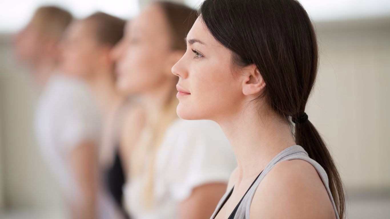 A woman sitting practising mindfulness-based movement