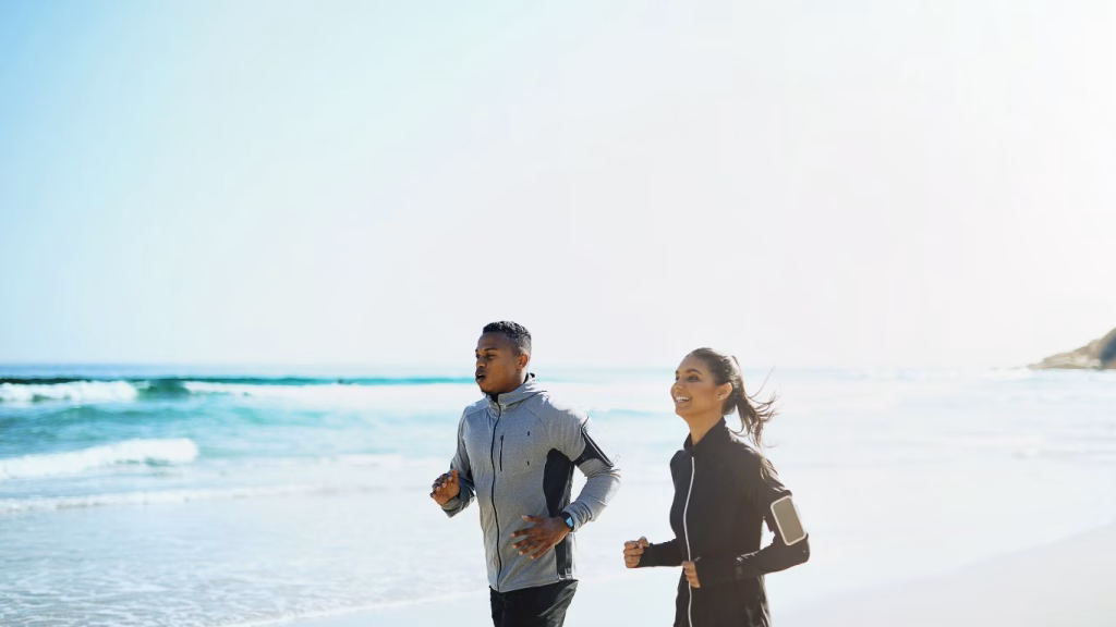 Man and woman running on the beach