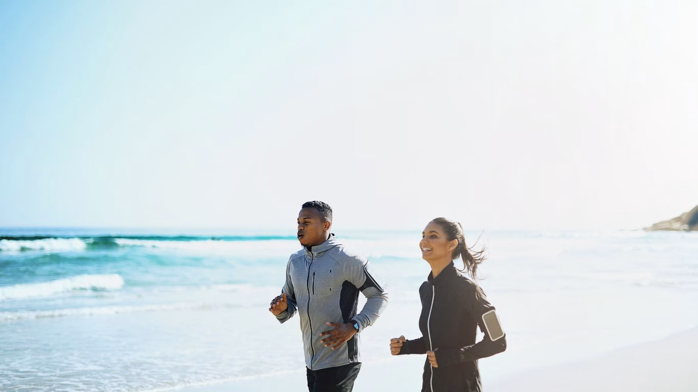 Man and woman running on the beach