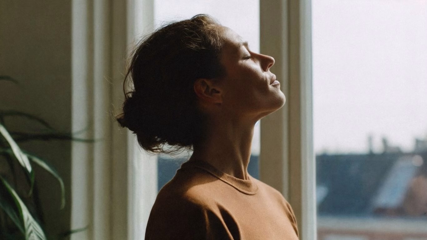 A woman with her eyes closed, inhaling and looking calm