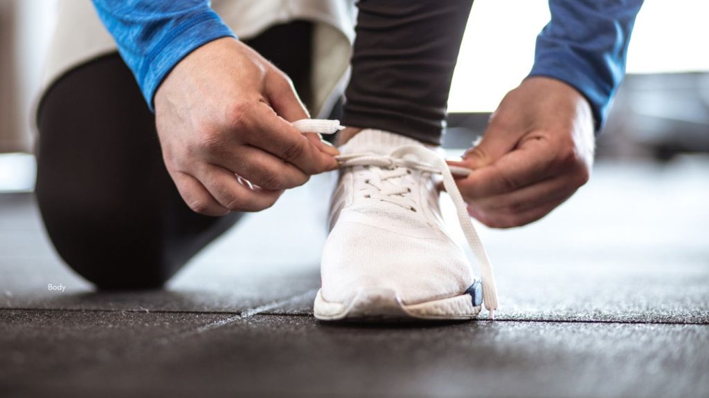 Image of athlete tying their shoelace