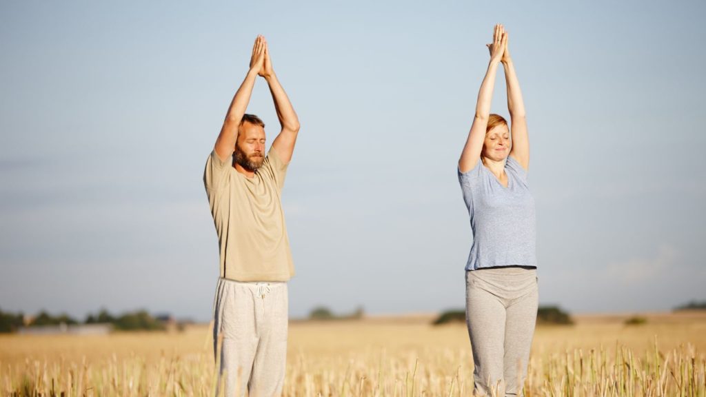 Man and woman stretching in the sun