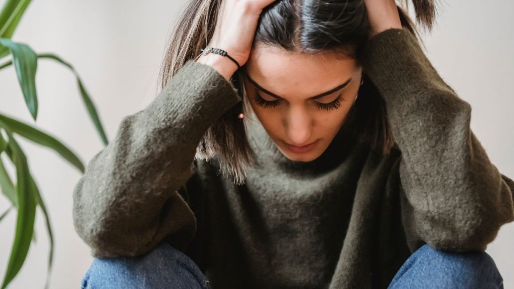 A woman with her head in her hands