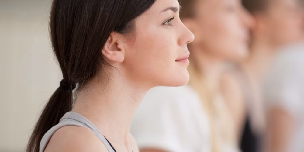 A woman sitting practising mindfulness-based movement