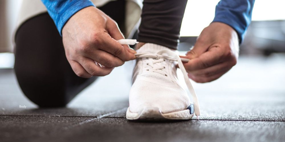 Image of athlete tying their shoelace
