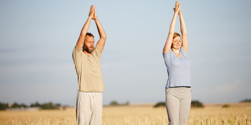 Man and woman stretching in the sun