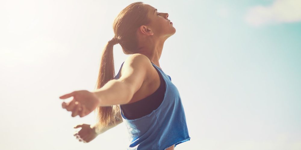 Image of woman with arms outstretched