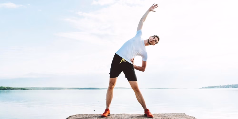 A man stretching gently using somatic movement